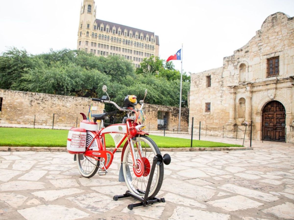 Bike held upright in front of the Alamo museum.