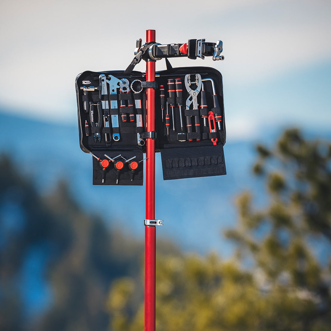 feedback sports team edition toolkit hanging on a pro mechanic bike repair stand at a trailhead