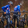 Two road bike racers in blue removing bikes from A-Frame bike storage stand.