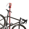 Bike hanging from digital weight scale in bike repair stand.