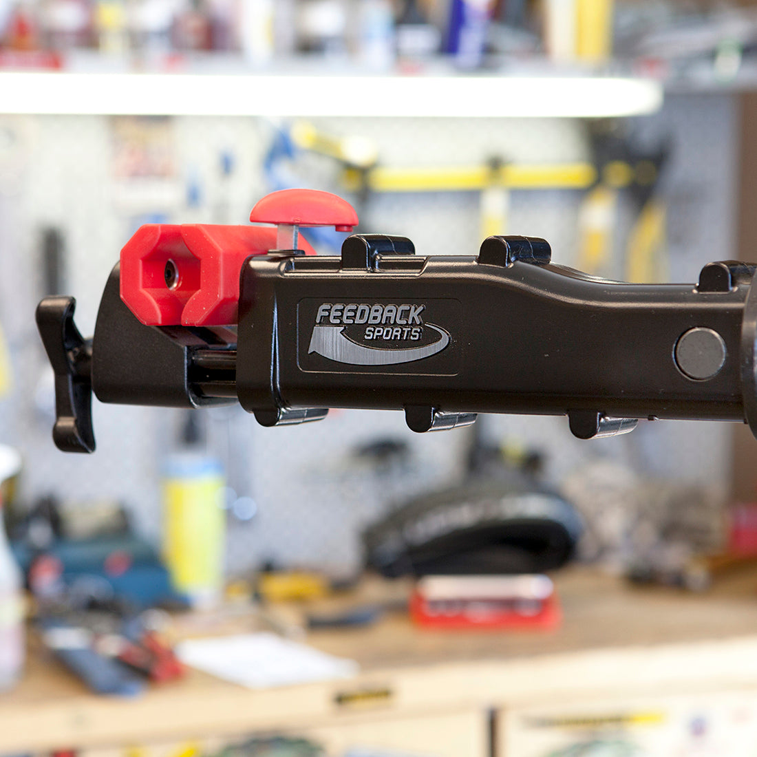 Bike repair stand clamp jaw in close up in bike shop setting.