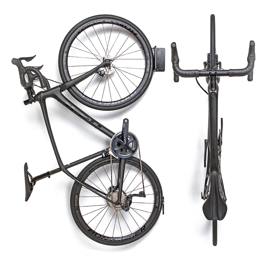Two black road bikes suspended on wall with Velo Hinge folding bike storage hook.