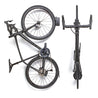 Two black road bikes suspended on wall with Velo Hinge folding bike storage hook.