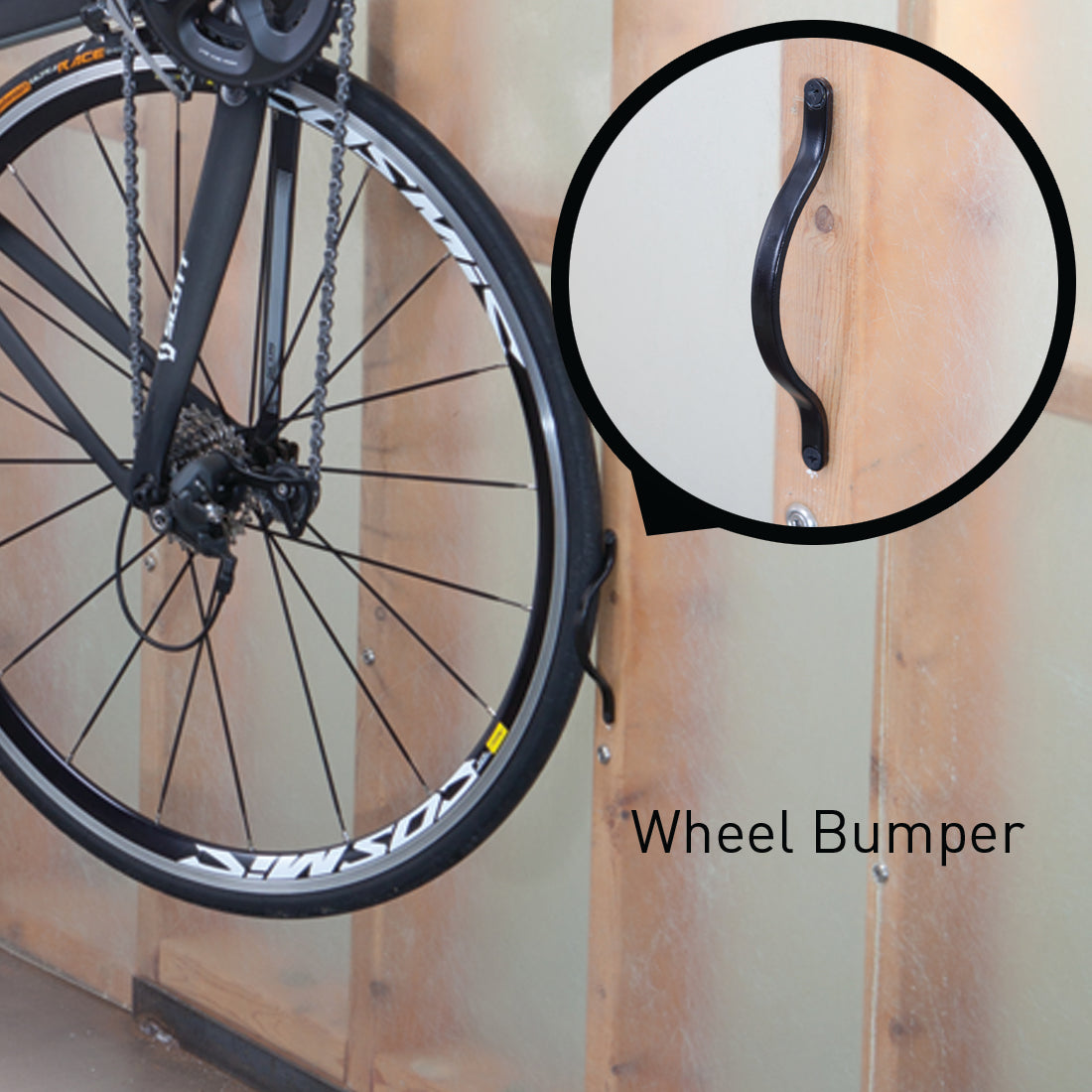 Close up of bike rear wheel on Velo Hinge rear wheel bumper on wall.