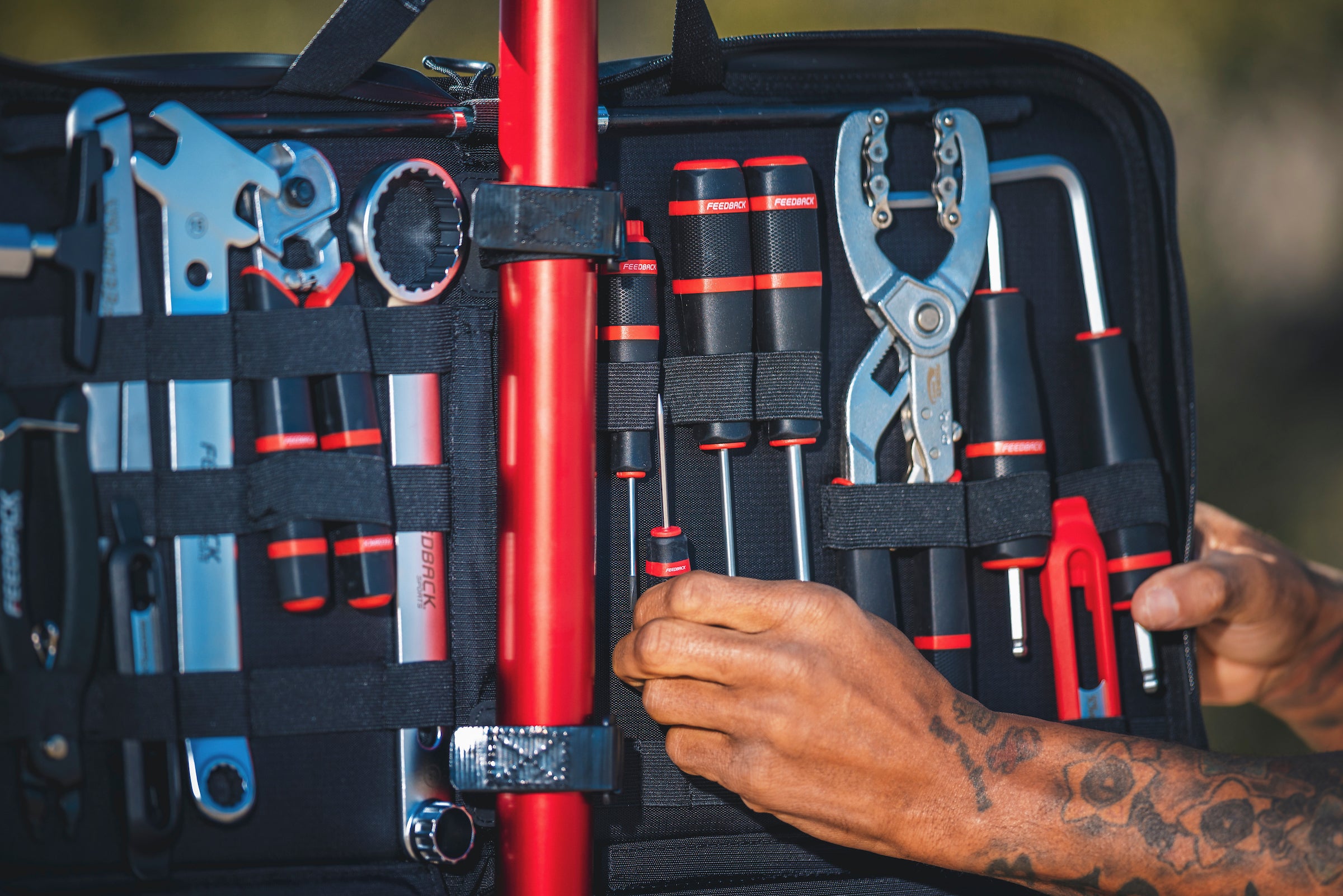Bike tool kit close up with person removing tool.