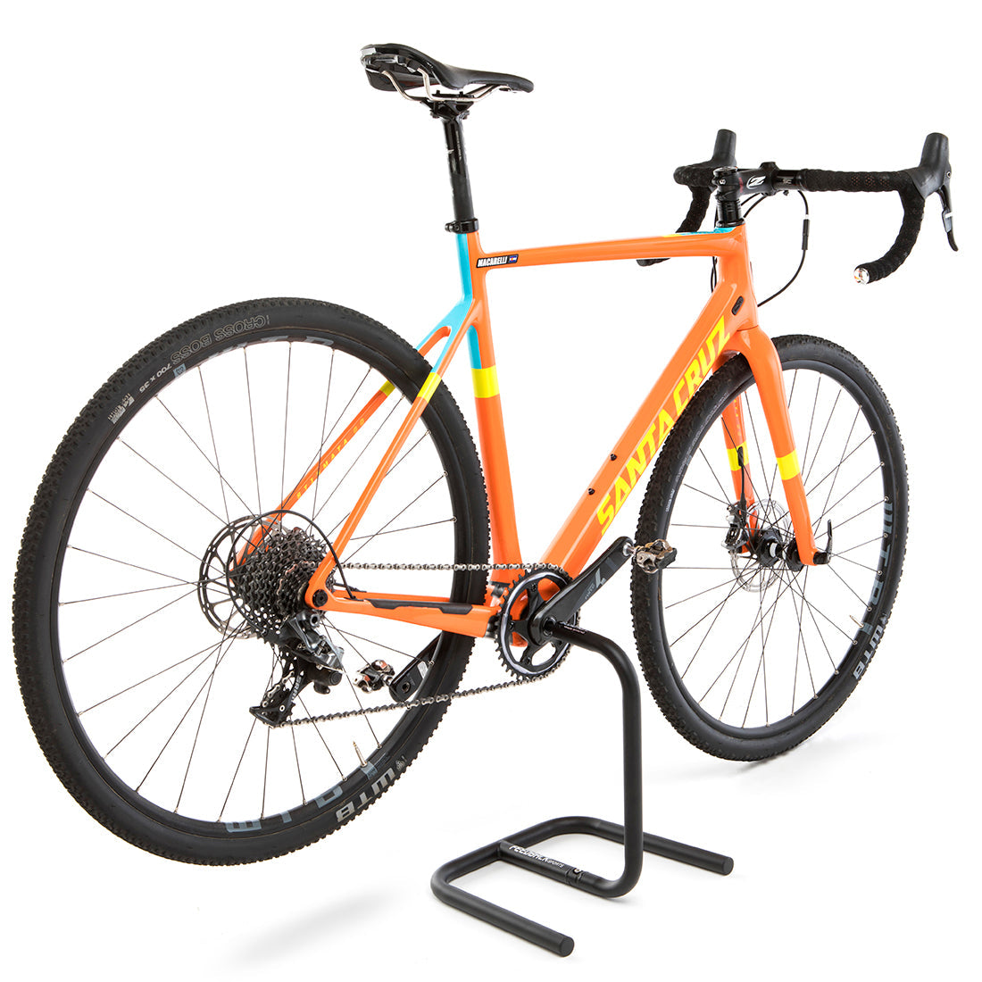 Orange cyclocross bike installed in Scorpion bike storage stand in studio.
