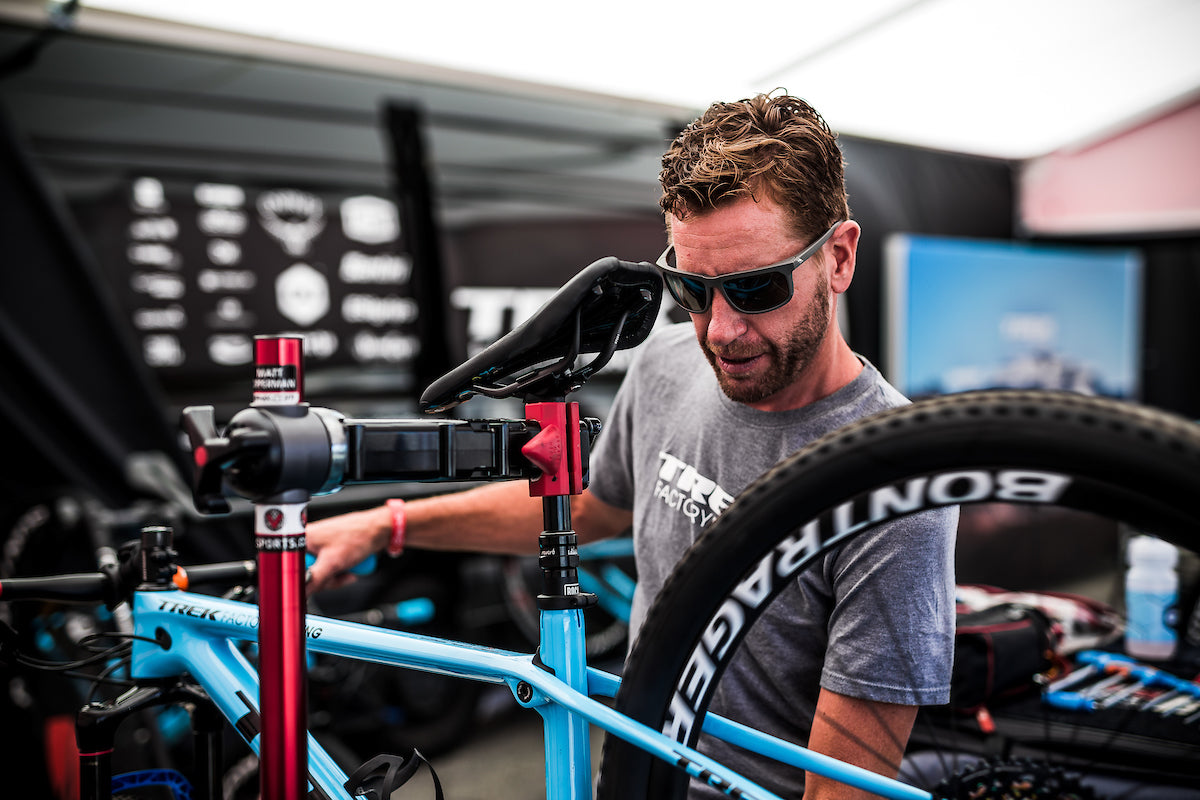 professional mechanic working on a bike in a pro elite repair stand