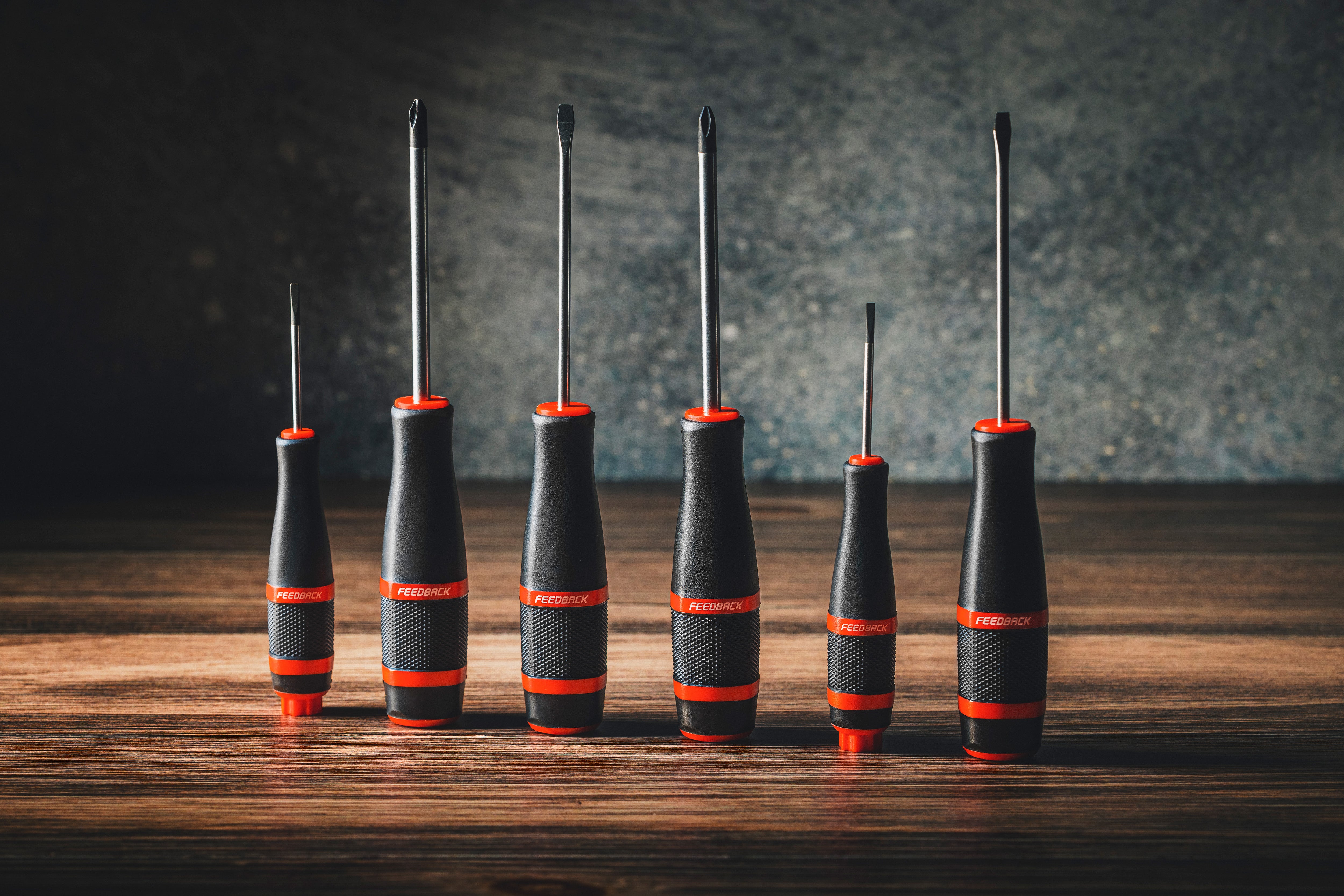 screwdrivers lined up on wood