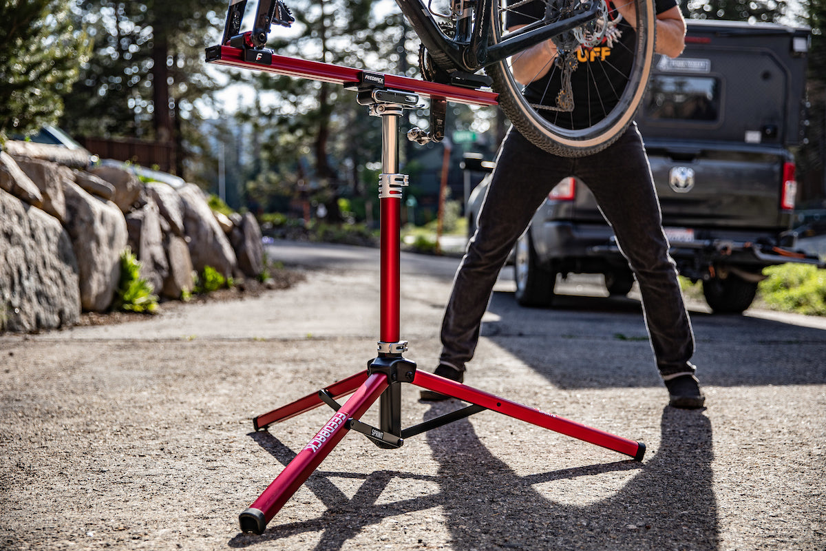 professional mechanic working on a bike using a sprint repair stand