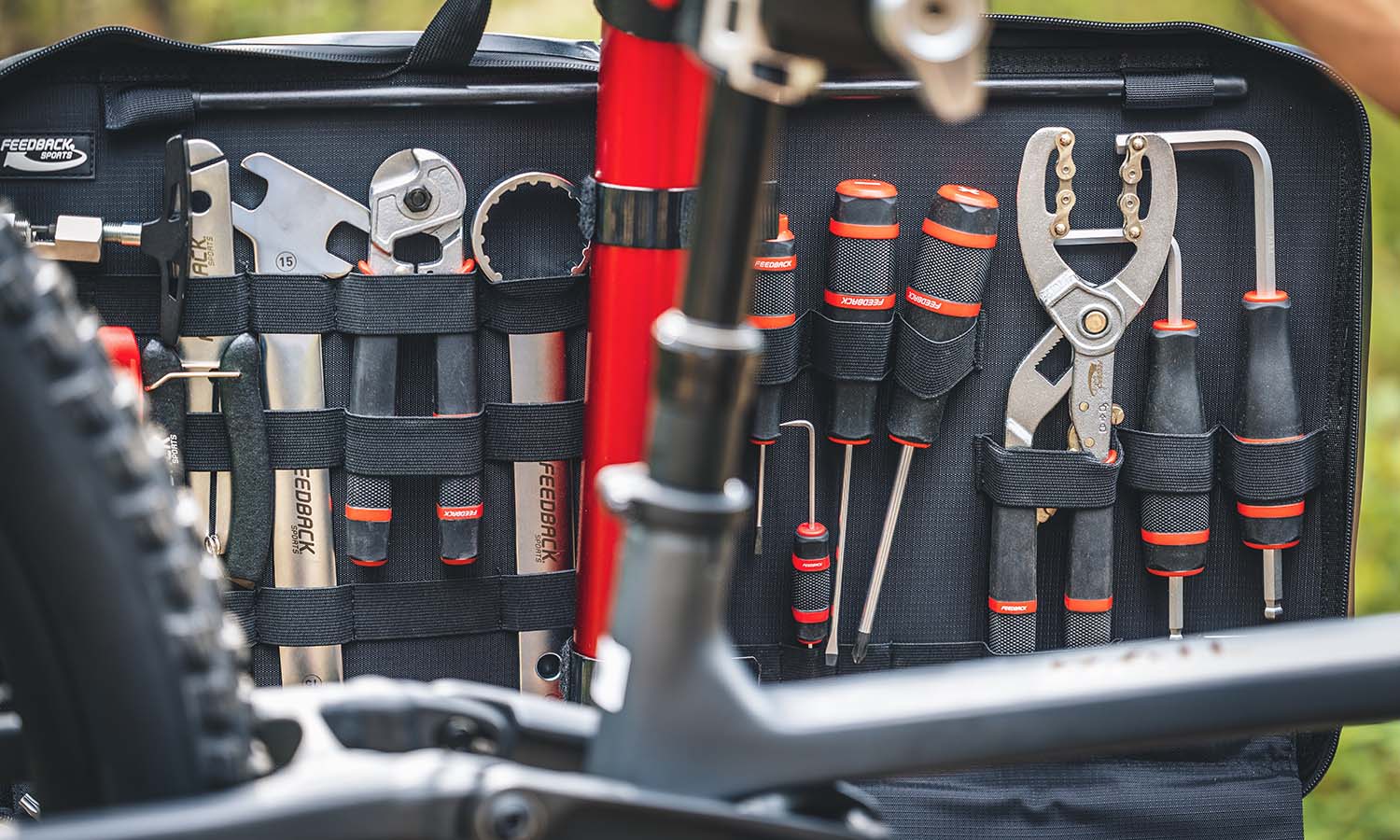 Close up of a bicycle tool case mounted on a bike repair stand.